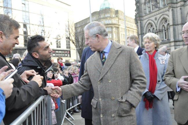 Prince Charles chats to the crowd as he arrives at City Hall in Bradford.