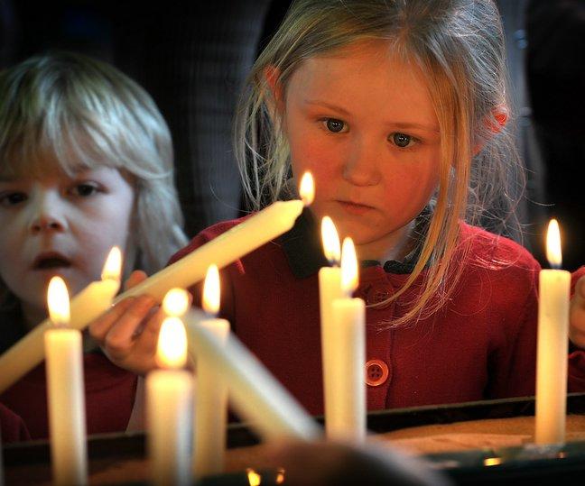 Victims and survivors of the holocaust and other genocides were remembered yesterday in a moving ceremony at Victoria Hall, Saltaire.
Keelham Primary School pupil Tia Williams is pictured lighting a candle.