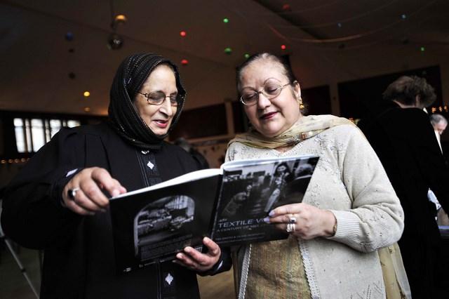 Former mill workers Latifa Bari, left, and Gurnam Bhangal reminisce at an event for Bradford mill staff in Little Germany