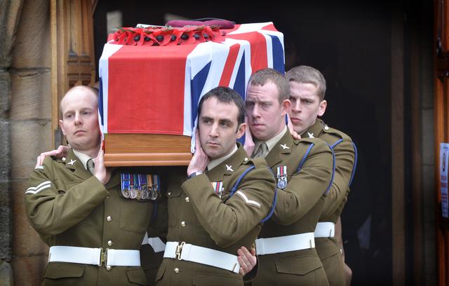 Colleagues of Private Martin Bell, carry his coffin out of Bradford Cathedral following his funeral service