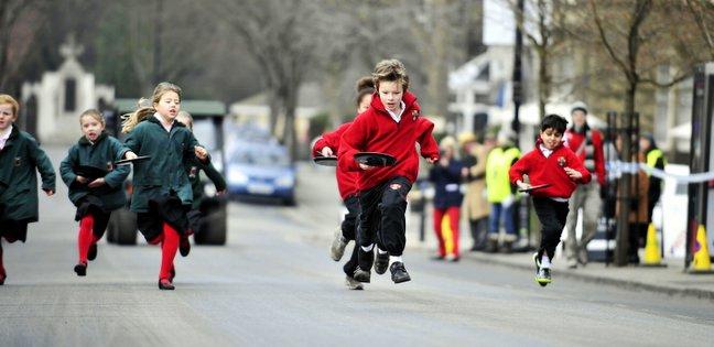 Pupils from various schools from around the IIkley area took part in a Pancake Day Race on The Grove in Ilkley, Pictured are pupils from Moorfield (green) and Ghyll Royd (red) Primary Schools.
