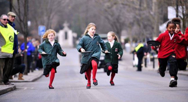 Pupils from various schools from around the IIkley area took part in a Pancake Day Race on The Grove in Ilkley, Pictured are pupils from Moorfield (green) and Ghyll Royd (red) Primary Schools.
