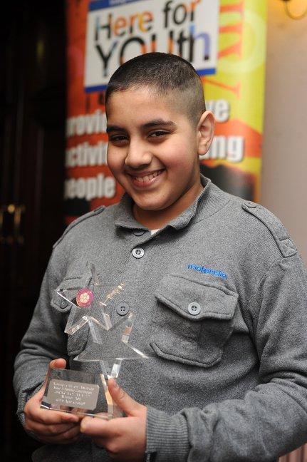 Israr Mohammed with the Make a Positive Contribution Under 11's Award.