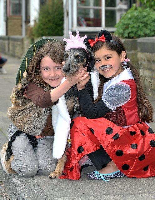 Shauna Kelly, left, and Anyah Morgan get in the dress-up royal mood with Maggie the lurcher at Thornton