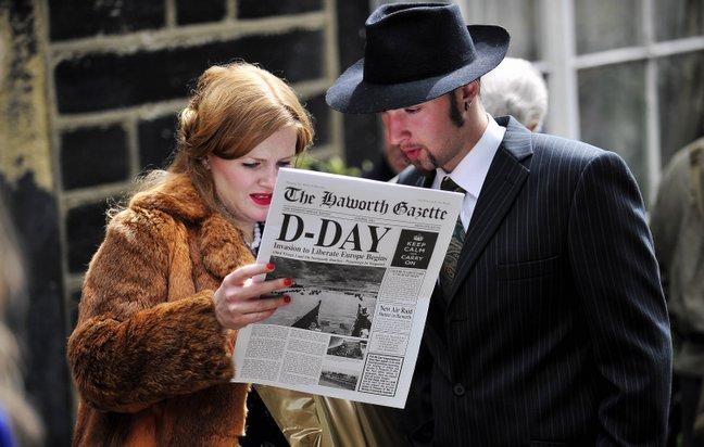 Visitors get into the 1940s mood, as a couple read through the Haworth Gazette.