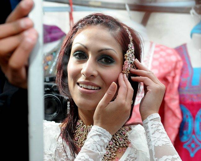 A day of music and dance with an international flavour brought thousands of visitors to Peel Park for Bradford Mela. 
Samara Begum is pictured trying on some jewellery.