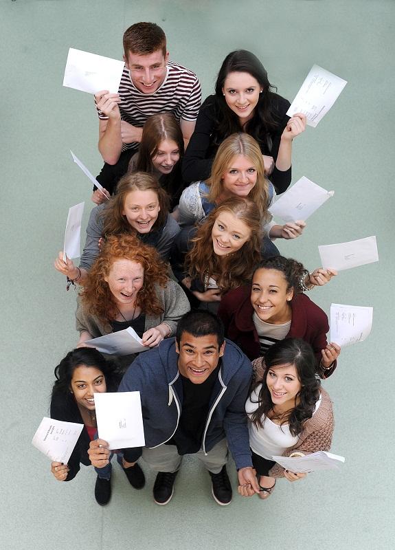 Students wave their results papers at Beckfoot school, Bingley
