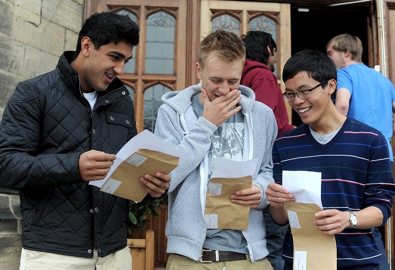 Shaan Rashid, Alex Browne and Alastair Kwan look at their results open their results at Bradford Grammar school
