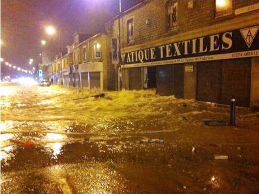 Water gushes down White Abbey Road after one of Bradford's main water supply pipes bursts