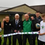 Barry Chaplin, chairman of the West Riding County FA, cuts the ribbon at the opening of Queensbury Celtic's new pavilion