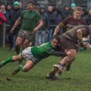 A Wharfedale player flies in to tackle a Huddersfield ball carrier. Picture: Ro Burridge