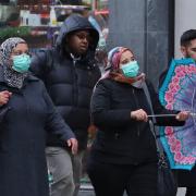 Women wearing protective face masks in Oxford Street in London. Picture: Gareth Fuller/PA Wire