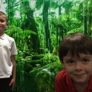 Above, pupils broadcasting live from the ‘rainforest’, and right planting a tree
