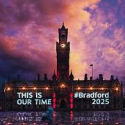 Promotional image by Bradford 2025 shows the City of Culture slogan projected onto City Hall in a mystical scene