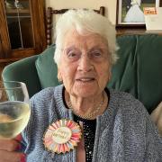 Annie Hughes raises a glass on her 100th birthday