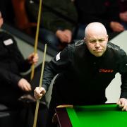 David Grace (left) spent most of his first-round match against John Higgins sat in his chair, with the Scot imperious in his 10-3 win over the Bradfordian.