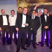 Members of the Schofield Sweeney team celebrate the award