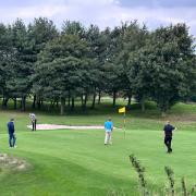 Andrew Busfield (ready to putt) and Oliver Tasker (far right) in action on Sunday
