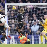 Patrick Bamford (in white) twists into position to head home Leeds' opening goal.