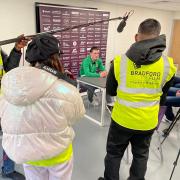 University of Bradford students film City striker Calum Kavanagh being interviewed in the pre-match press conference