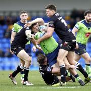 Max Wood (green) gets tackled in Warrington's Super League victory at London Broncos earlier this month.