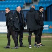 Graham Alexander on the pitch with officials before the original Barrow game was called off