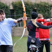From left, University of Bradford students Dean Dowling, Imran Khan, Shelly Hurst and Gemma Jackson take part in an archery contest during the Colours Carnival