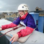 Student Nurse Katy Dunn goes over the edge of the 7th floor rooftop of Bradford's Jurys Inn hotel for the T&A Crocus Cancer Appeal