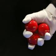 A snooker referee holds three red balls