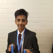 Raeece Hussain shows off his medals