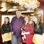 Darren and Sue Robinson, centre, the new landlords of the Golden Fleece in Oakworth, with members of staff