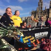 The Lord Mayor of Bradford Councillor Geoff Reid with representatives from charity Young Minds at the unveiling of this year's Dragonboat Festival in City Park