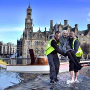 Lady Mayor Chris Reid is carried from the boat without getting her feet wet..