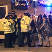 Police console fans after last night's bombing at an Ariana Grande concert in Manchester. Photo: PA Wire