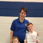 Philippa Johnson-Barratt with her daughter Sienna and son Rhys after the family all passed gradings