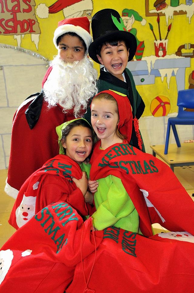Father Christmas Byron Hyman, seven, and Uncle Holly Hamza Razzaq, six, with elves Eliza Hussain and Megan Nuttall, both six, from Heaton Primary School in Bradford