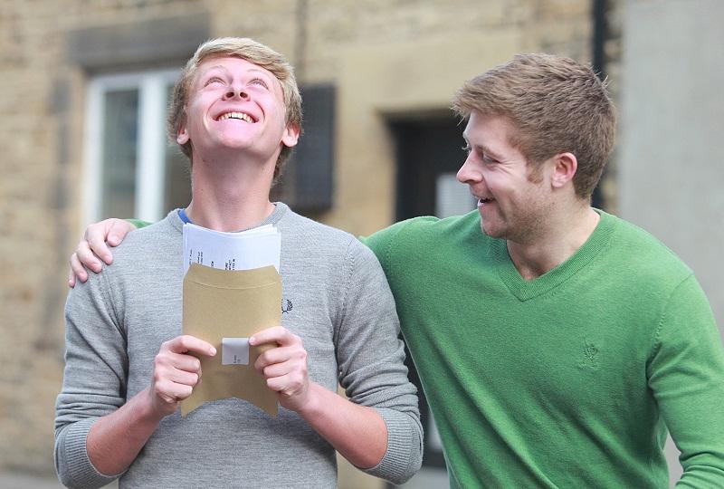 Pupils collect their GCSE results at Ermysted's Grammar School, Skipton - Ali Jordan with his brother and past pupil James