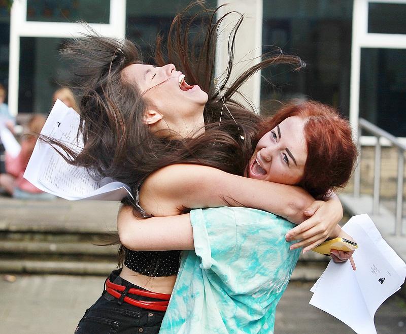 Pupils collect their GCSE results at Skipton Girls' High School - Daisy Lee can't contain her excitment after getting 15 A stars, and gets a hug from her friend Harriet Machesi