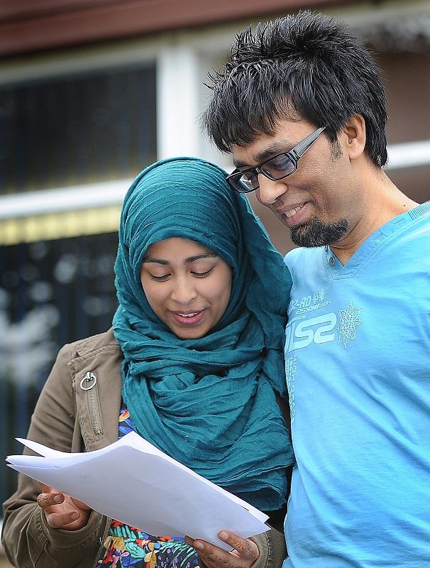 Saarah Islam shows her GCSE results to her dad, Naz Islam, at Samuel Lister College