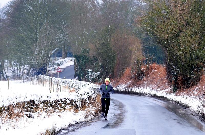 A runner braves the snowy conditions in Guiseley