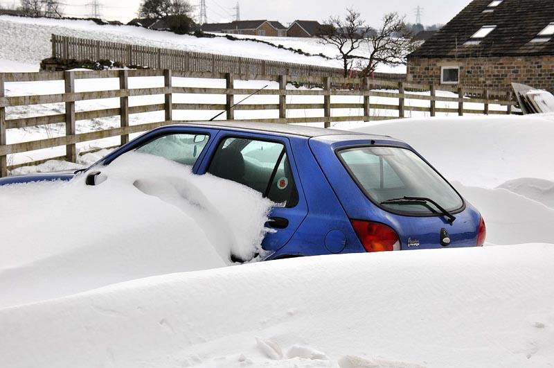 A car stuck in snow drifts in Wisden