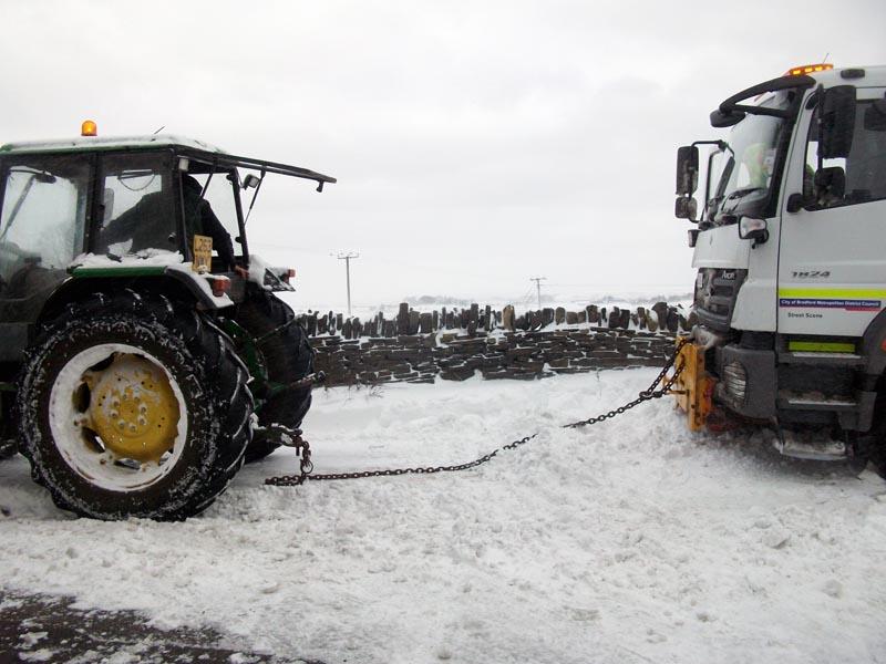 A T&A reader uses his tractor to tow a gritter on Back Lane, Thornton, Bradford