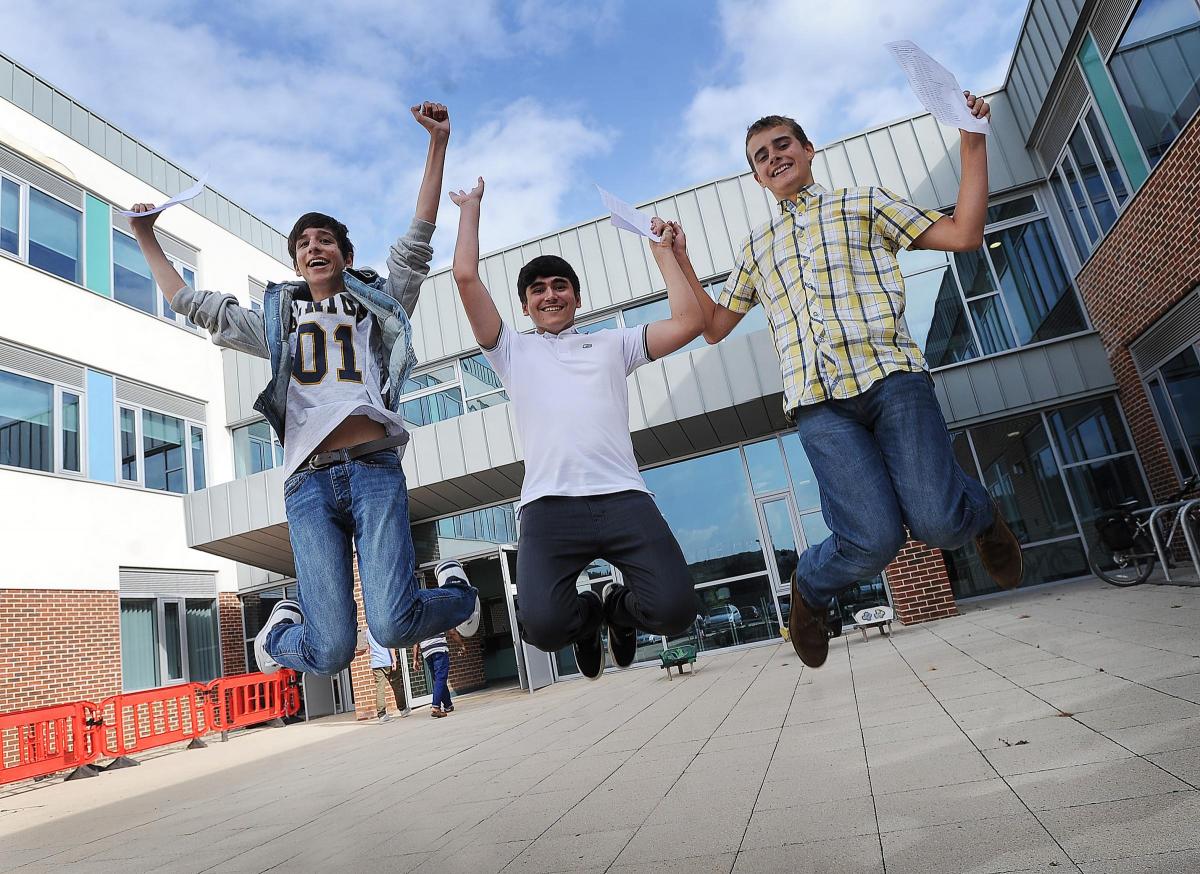 With 12 A* grades each, Nathanial Keidan, Aimen Hassan and Felix Bunting jump for joy on GCSE results day at Beckfoot Grammar School