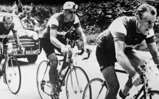 Brian Robinson, right, races in the 1956 Tour de France. Picture: PA