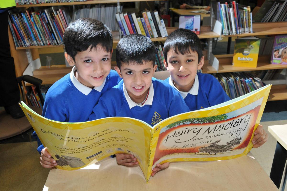 Keighley Library celebrates World Book Day with children from Victoria Primary School.Enjoyingreading a book Saifali Mohammed, 7, Danyal Mohammed, 7, and Shahzir Ali, 7