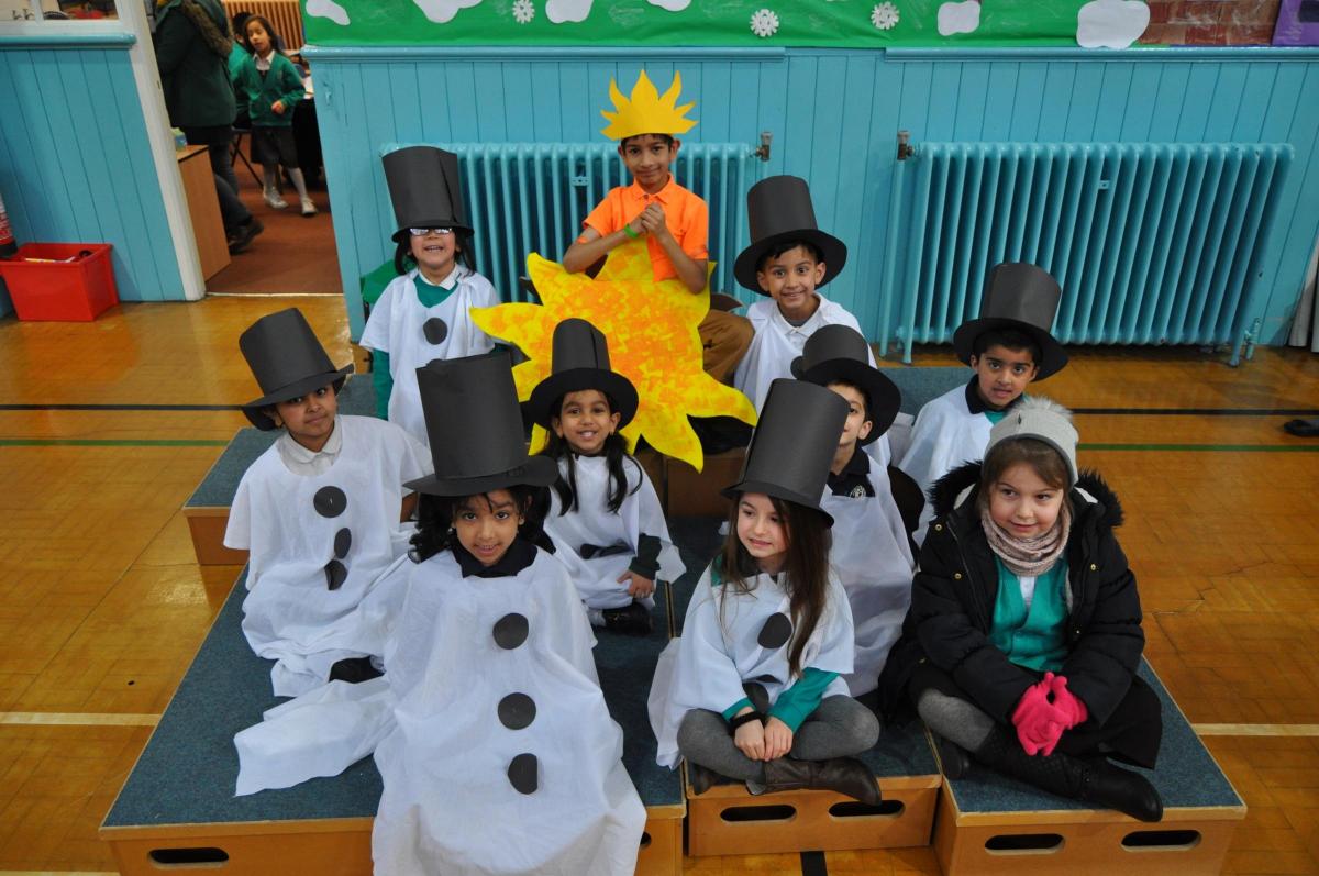 Frizinghall Primary School Foundation Stage and Key Stage One Christmas Production called 'Snowman at Sunset'. The photo includes children from both Year 1 and Year 2.