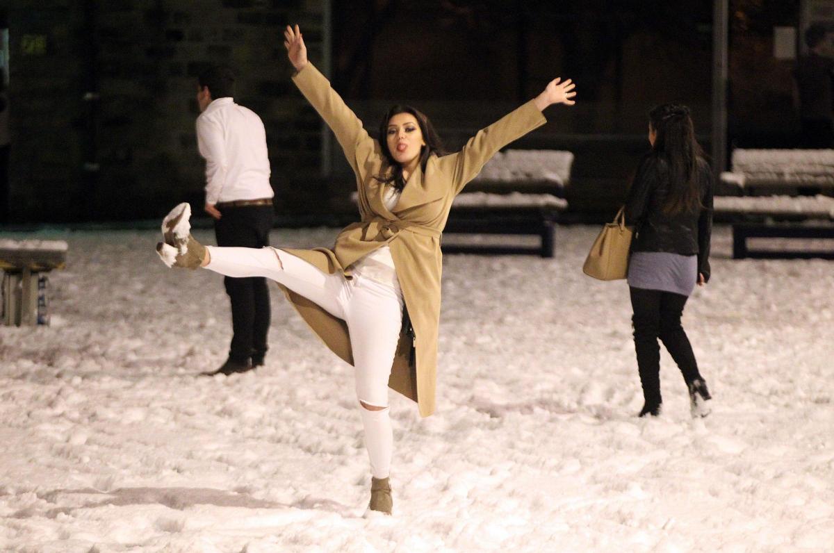 People on a night out in Bingley have fun in the snow. Picture: Nigel Bennett / nb press ltd