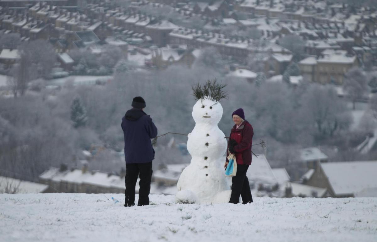 The first snowmen of 2016 appear...this one with panoramic views over Bradford  become an instant tourist attraction..Picture: Nigel Bennett