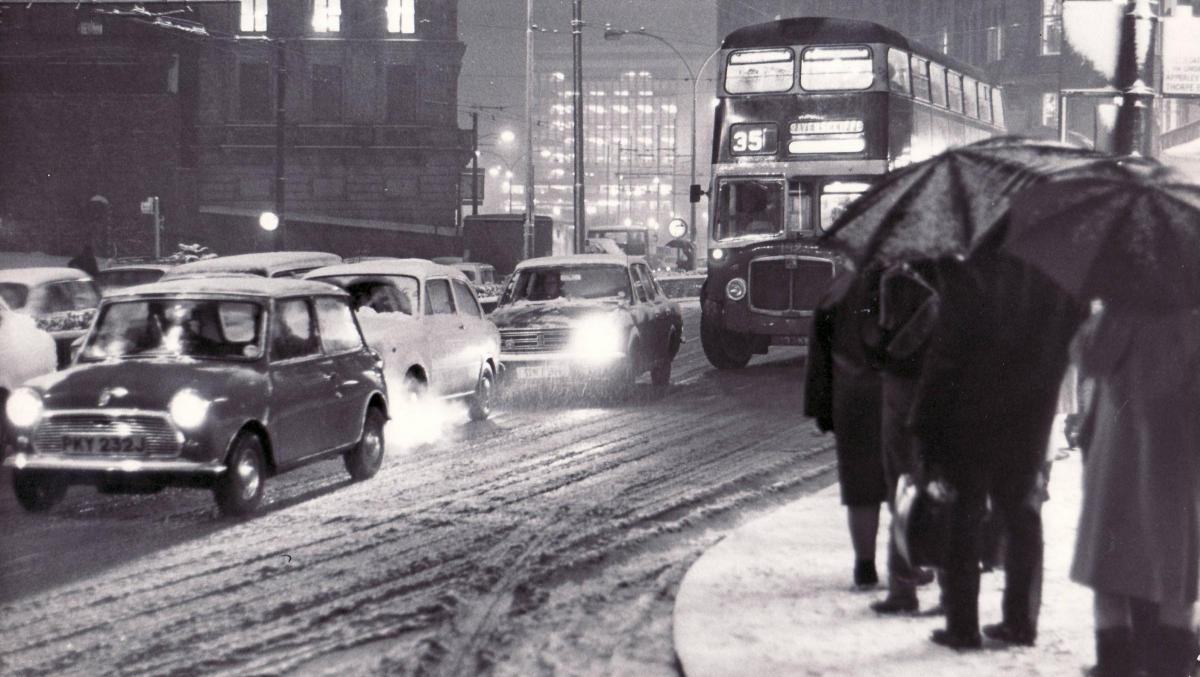 People wait for a bus in the snow in 1972