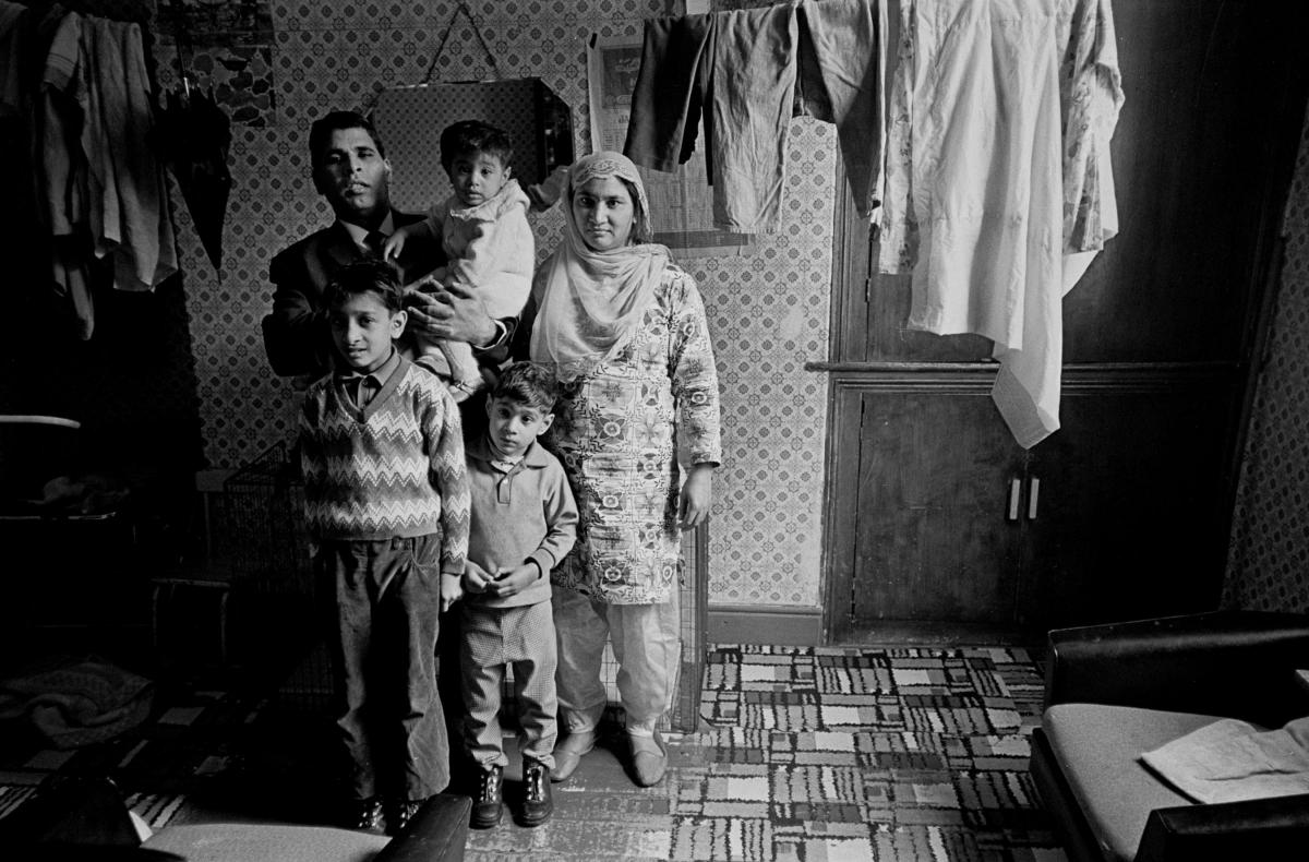 A family in their small home, where they had to hang their washing line in their living room.